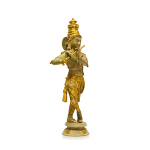 A small golden statue of a dancing figure playing a flute, standing on a round base against a plain white background.