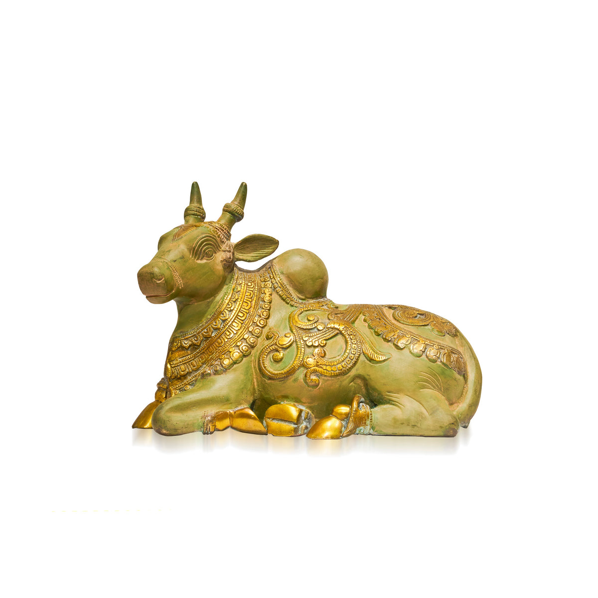 A small decorative figurine of a lying cow with ornate gold detailing and a greenish body, shown on a plain white background.
